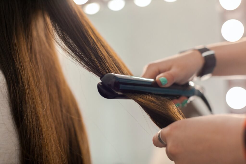 Hairdresser does hair style of woman